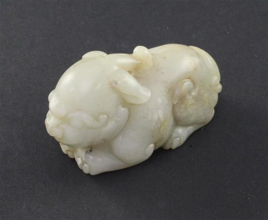 A small Chinese pale celadon jade figure of a recumbent chimera, 19th century, 5.8cm